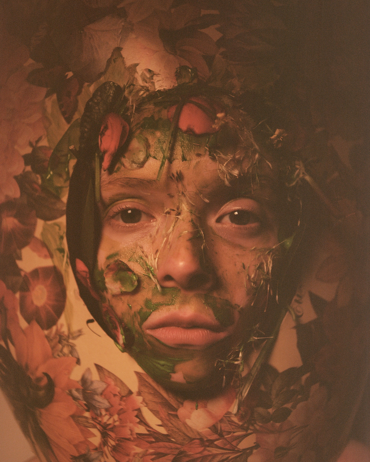 A model wears a headpiece and face paint decorated in flora and fauna.
