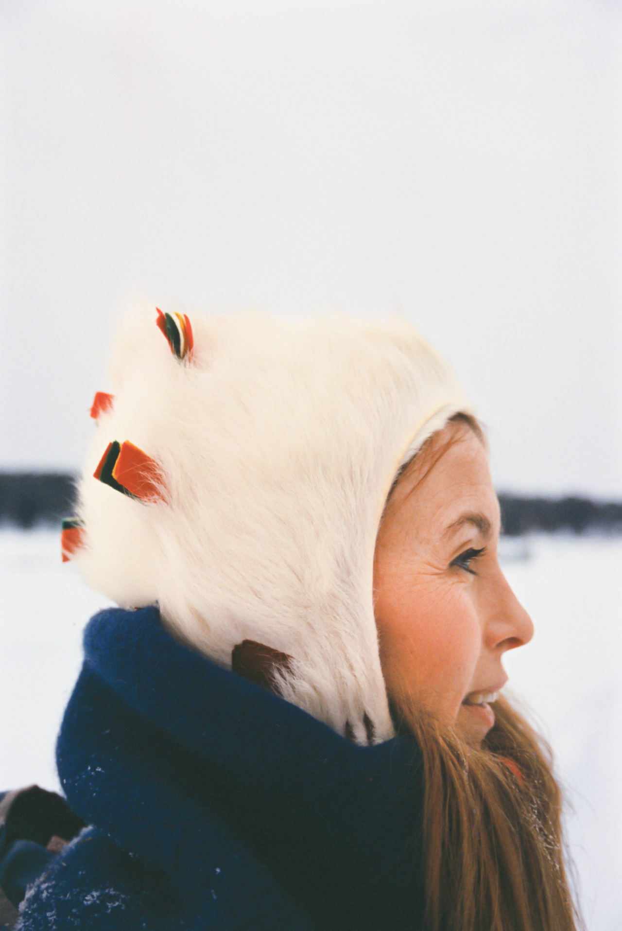 Sofia Jannok wears a snow hat while looking to the side.