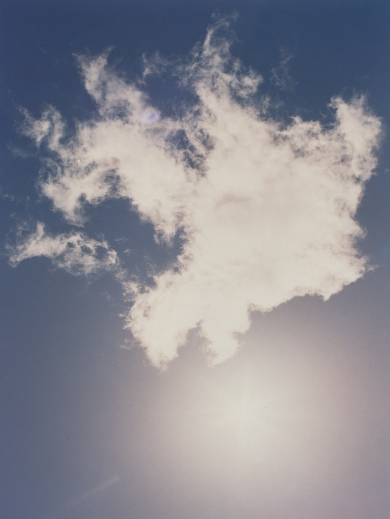 The sun barely shines in a muggy, cloud filled sky.
