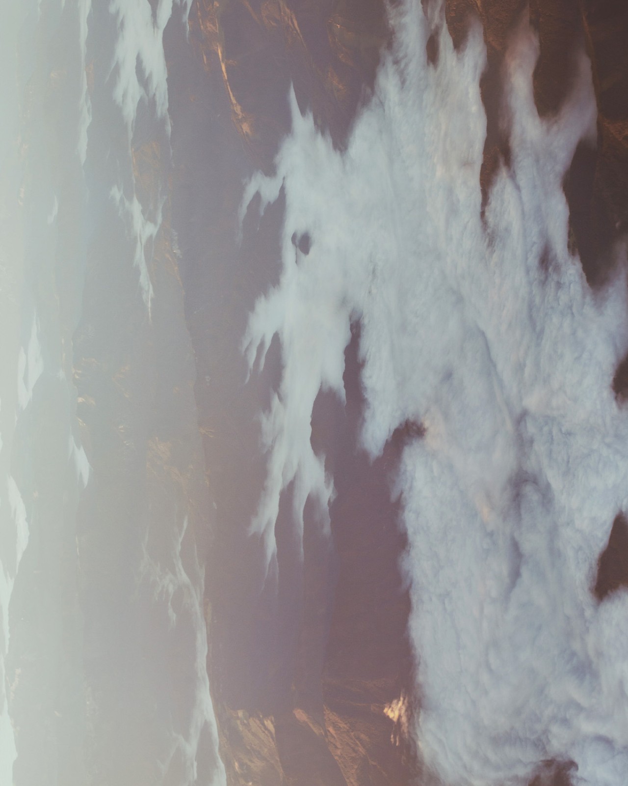 Clouds blanket the sky over a mountain range.