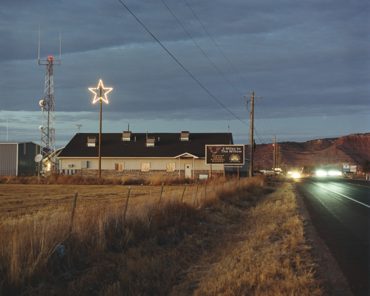A large house sits in the side of the road in Utah.