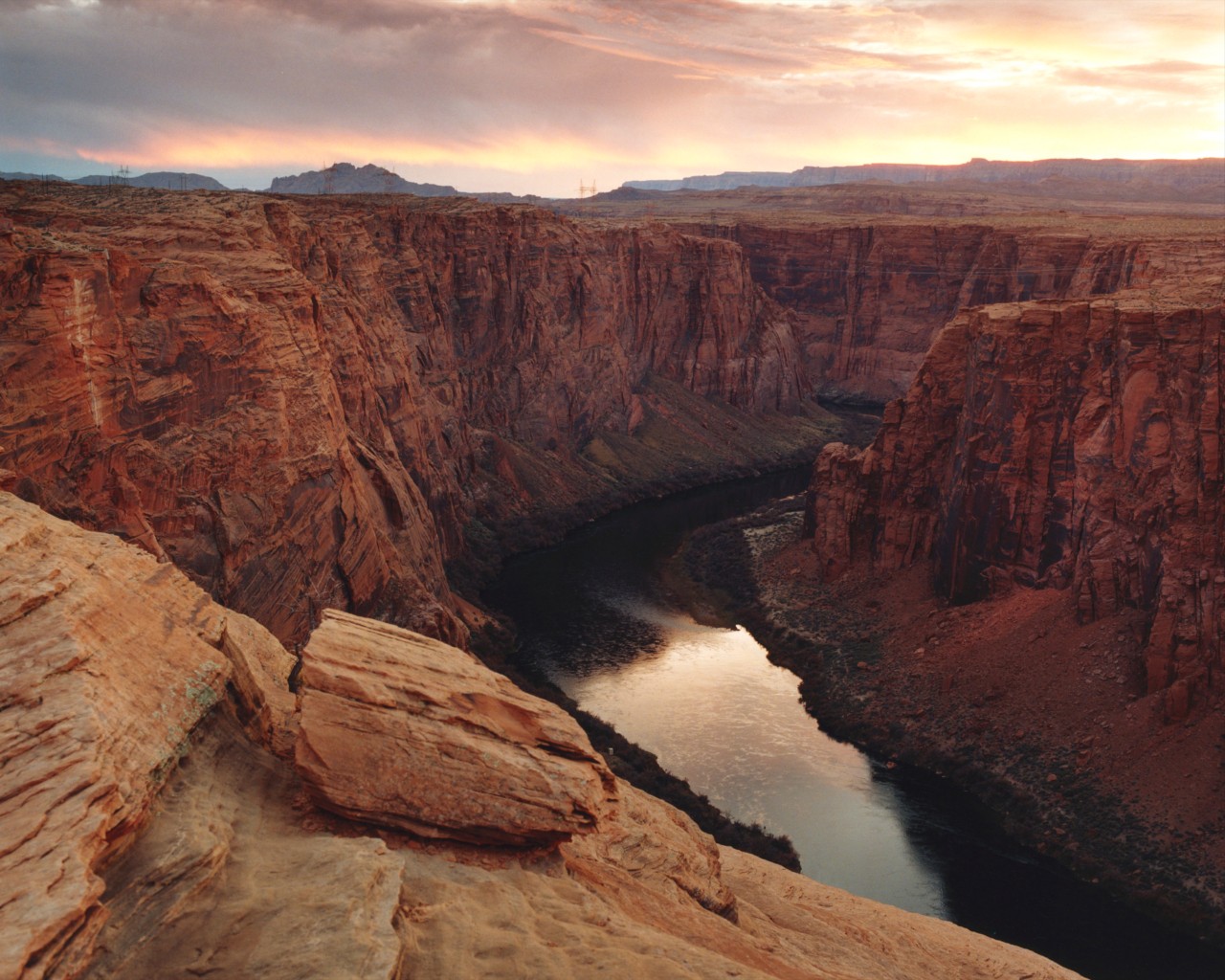 The sun sets behind the Colorado river.