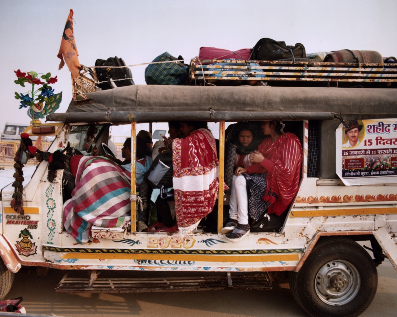 A group of families and neighbors take a break at Shastri Bridge during Kumbh Mela.