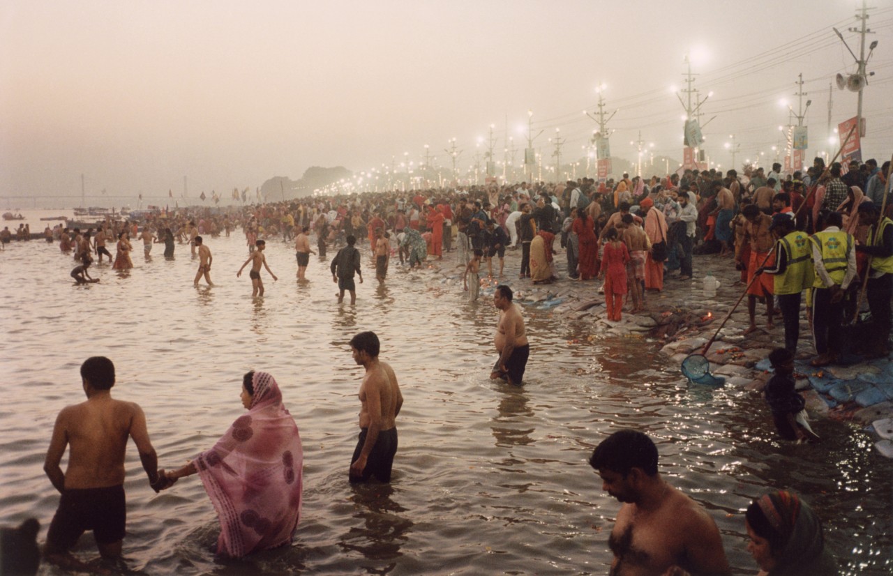 Pilgrims bathe at Triveni Sangam during Kumbh Mela.