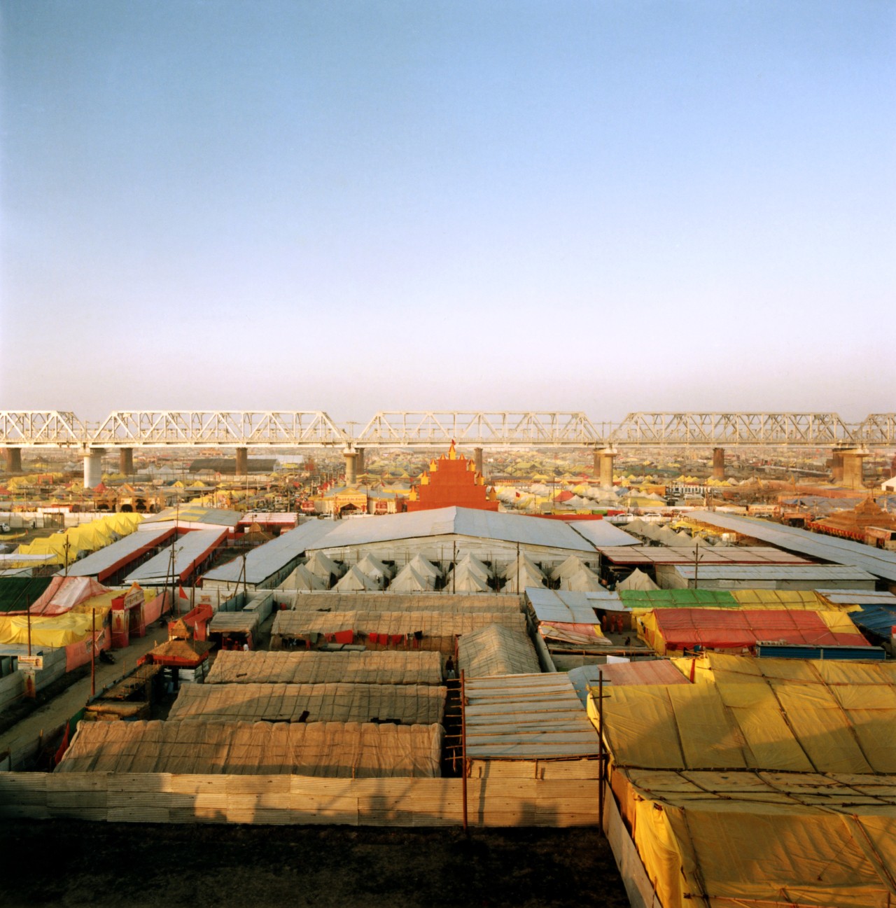 A view of tents and akharas (centers of spiritual learning) in the evening, taken from Shastri Bridge.