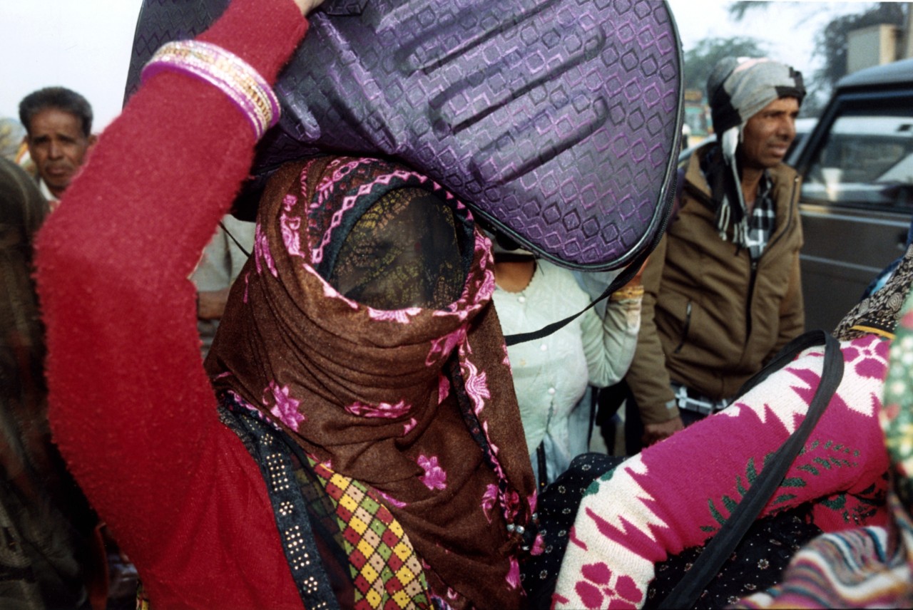 A woman wearing a ghoonghat walks from Rajasthan to Kumbh Mela.