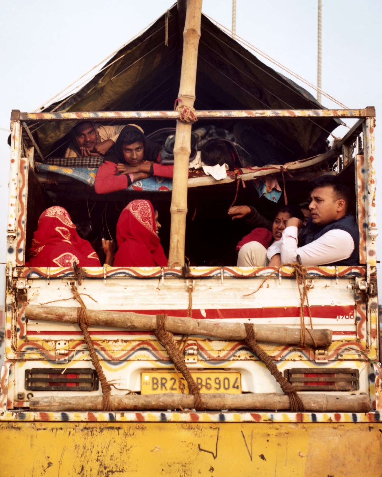 A group of families take a break at Shastri Bridge, Uttar Pradesh during Kumbh Mela.