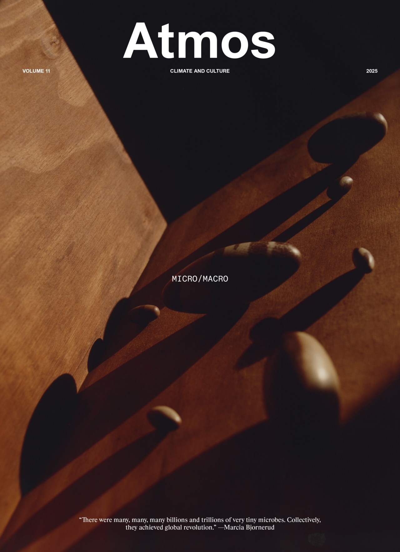 Cover of Atmos magazine, Volume 11, showing stones casting long shadows on a wooden surface with the words MICRO/MACRO at the center. Issue theme focuses on climate and culture, dated 2023.