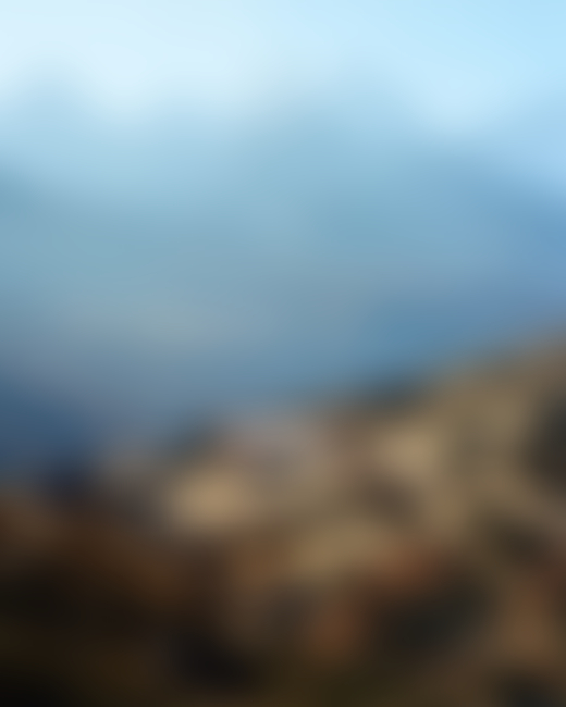 A lone house sits on a mountaintop.