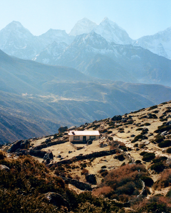 A lone house sits on a mountaintop.