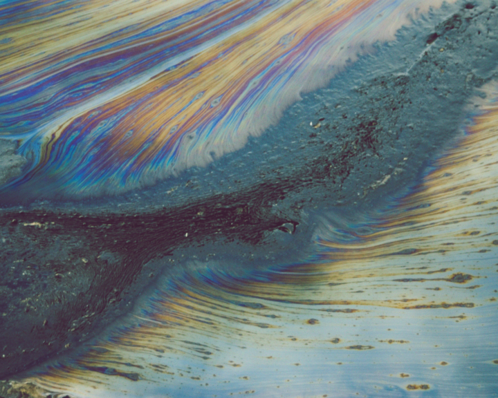 A water colored oil spill filled with an array of blues, pinks, and yellows.
