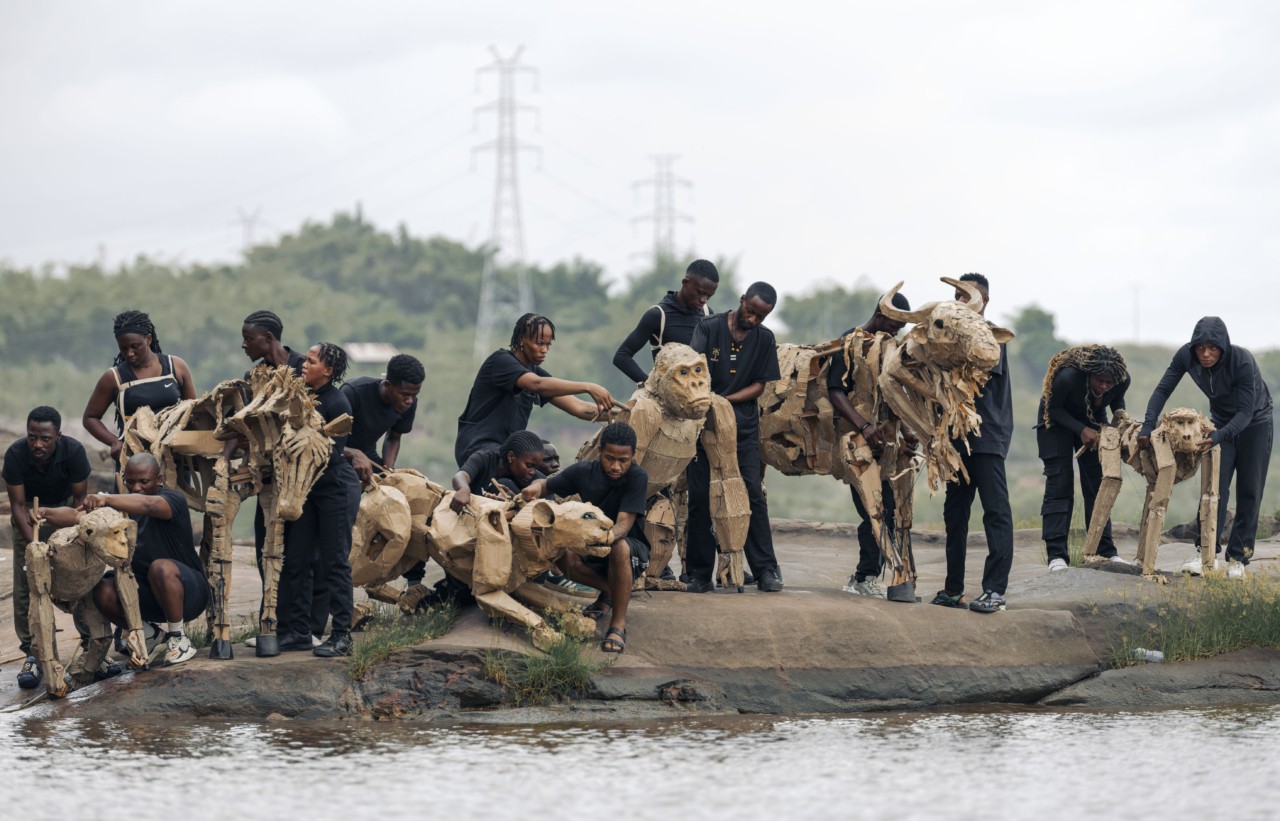 Several people carry animal puppets in the Congo Basin.
