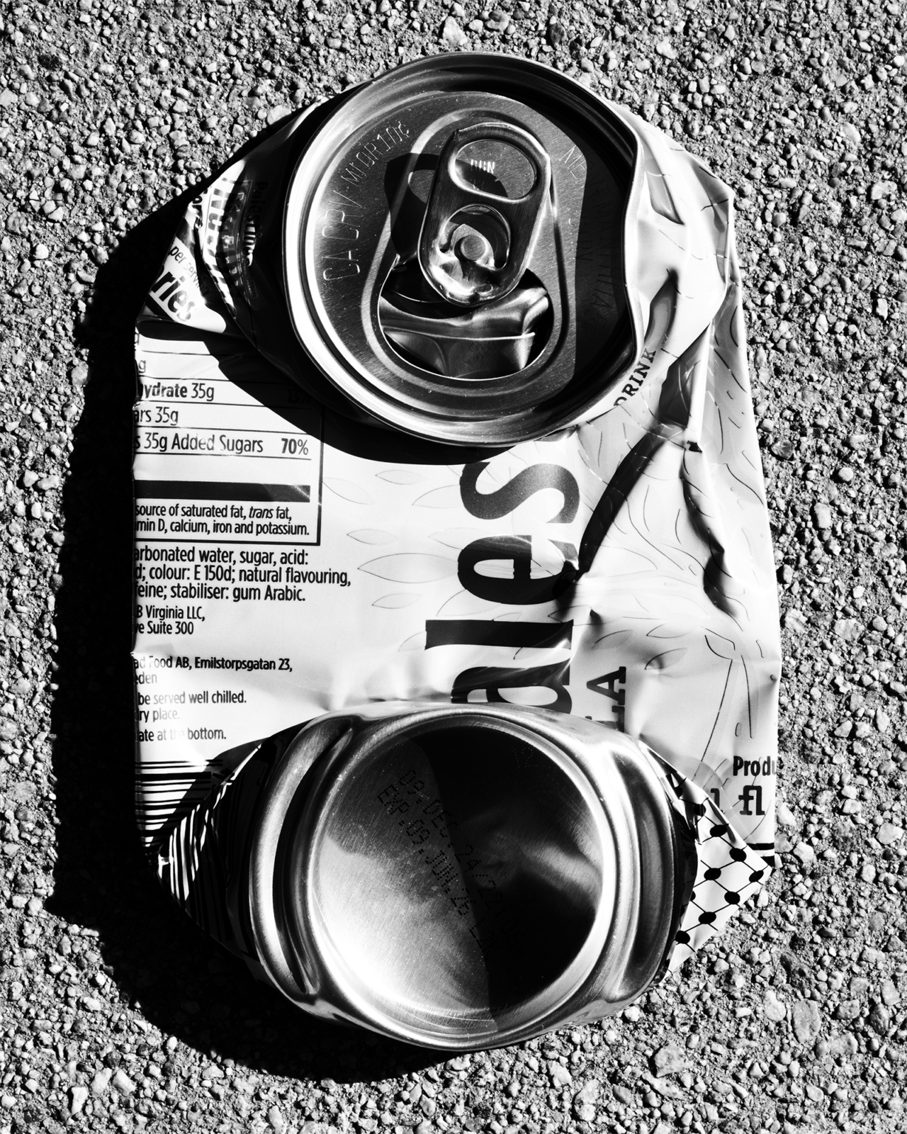 A crushed black and white can of Gaza cola.