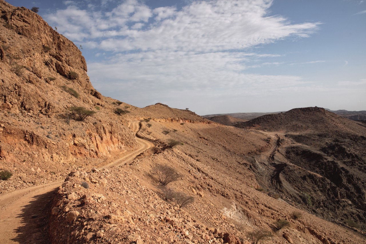 The side of a mountain reveals a trail.