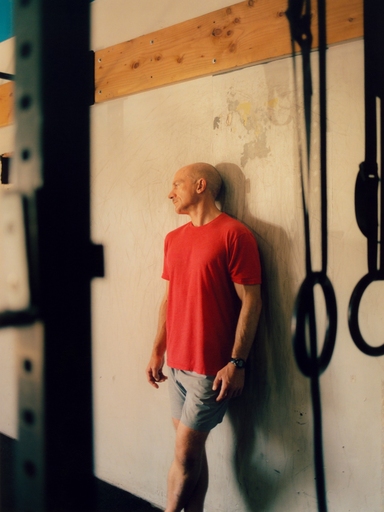 Southern California firefighter Aaron Katon leans against a wall at his CrossFit gym.