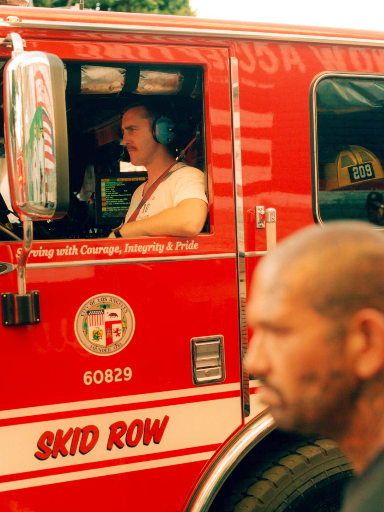 A Southern California firefighter sits in the driver seat of a firetruck.