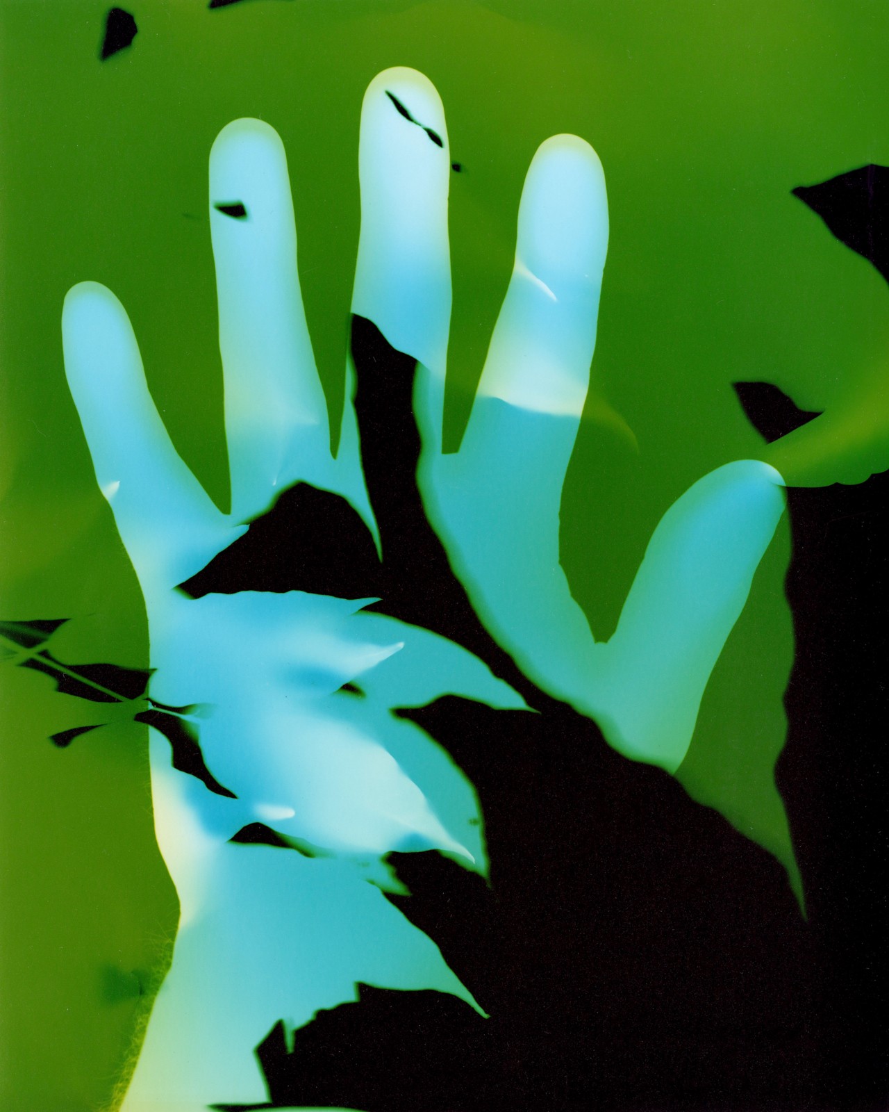 blue hand against a green and black background