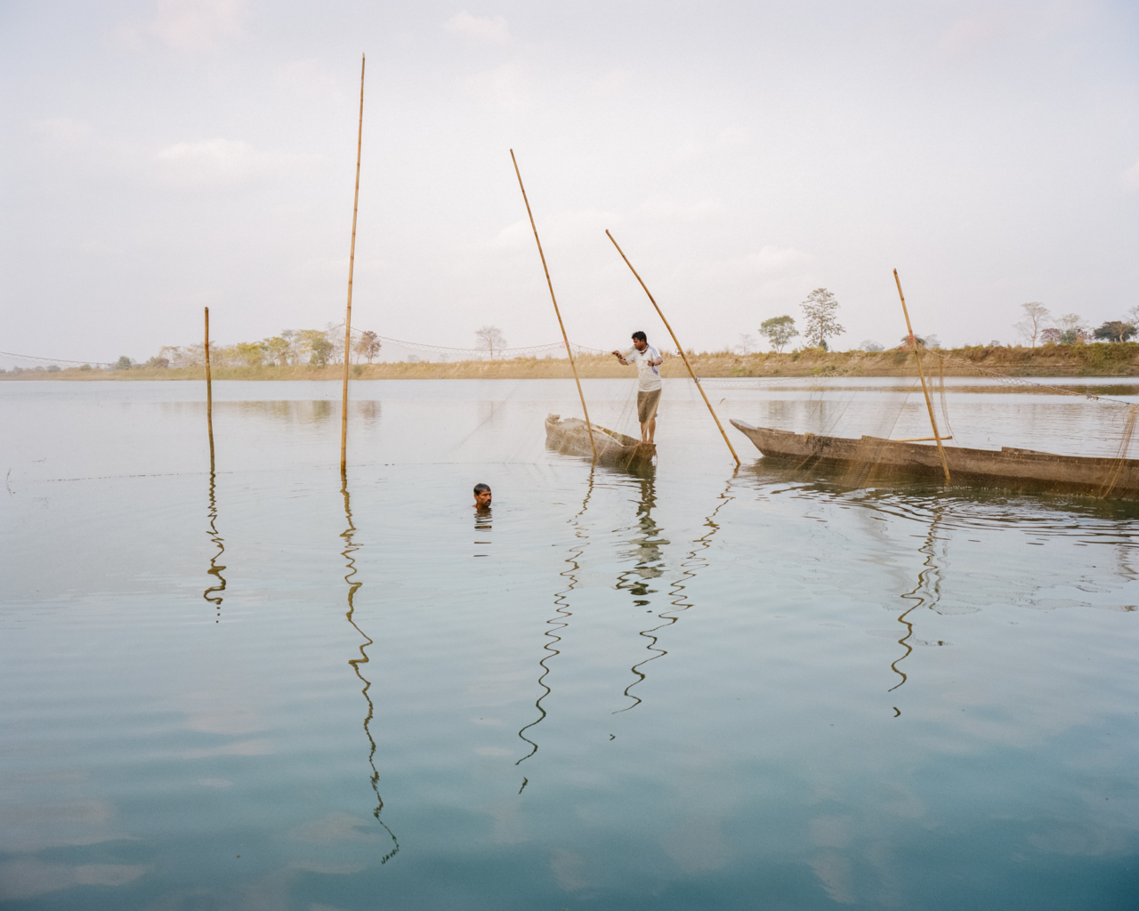 Men fish with a fenced trap called the ‚Jang’ on the Kherkata River, which is one of the inner branches of Brahmaputra and separates the island from the mainland on the north side. The families of the village come together and do the hard physical