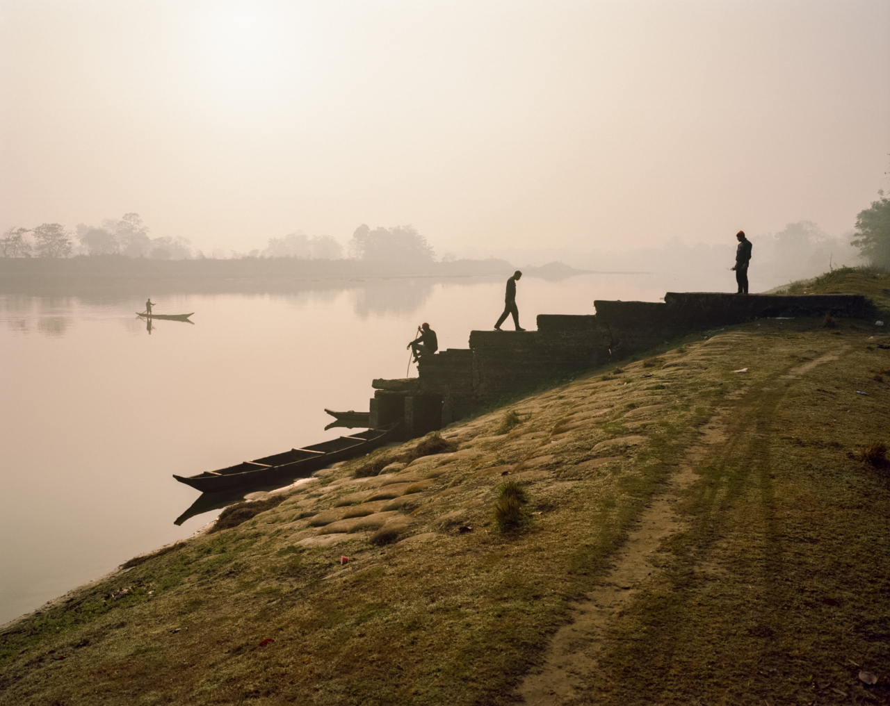 People walk up the steps that lead to the Brahmaputra river.
