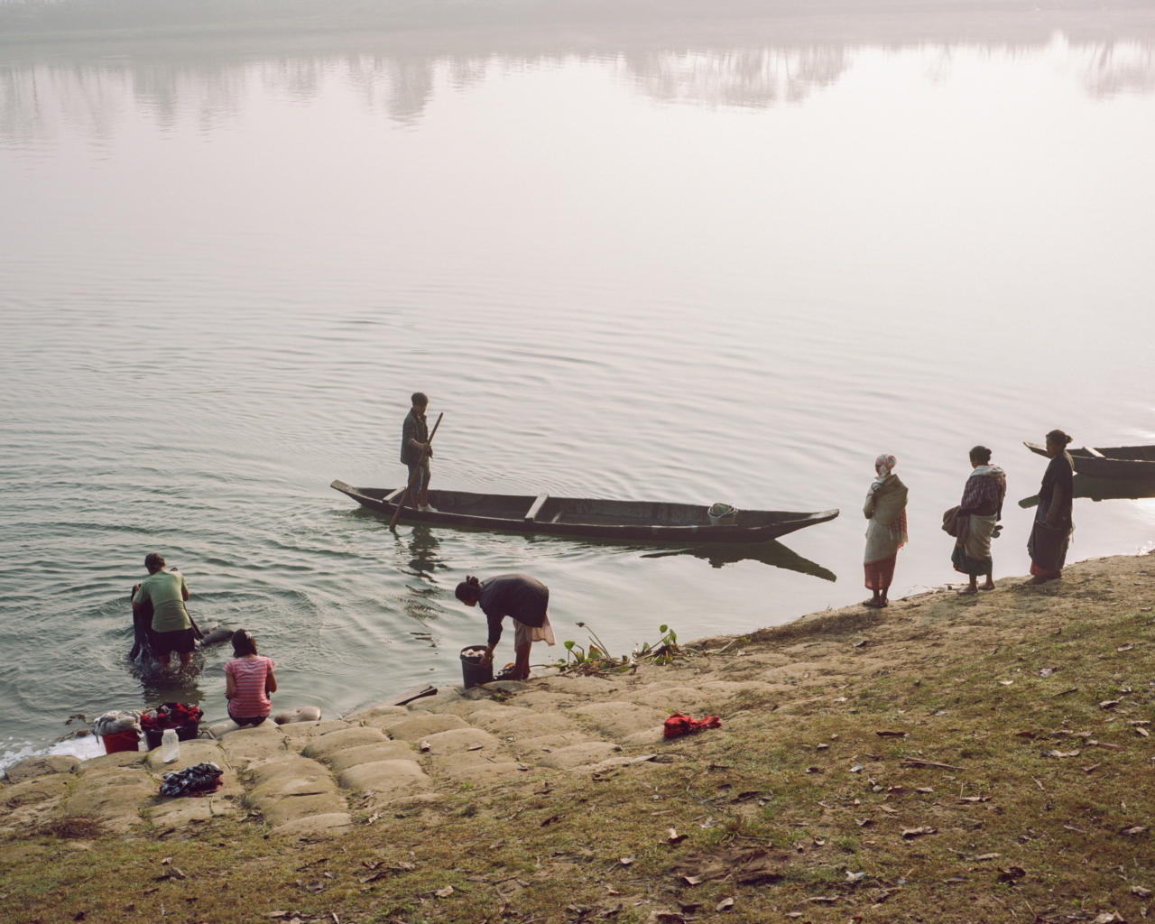 Several people on the bank of the Brahmaputra river.