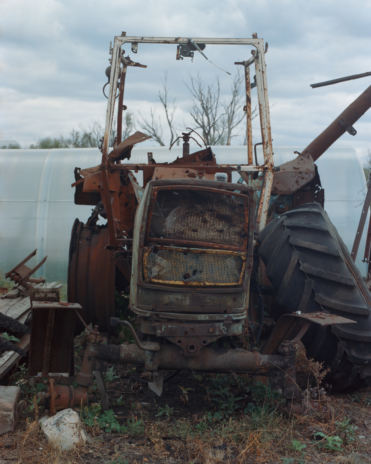 An abandoned tractor in a field.