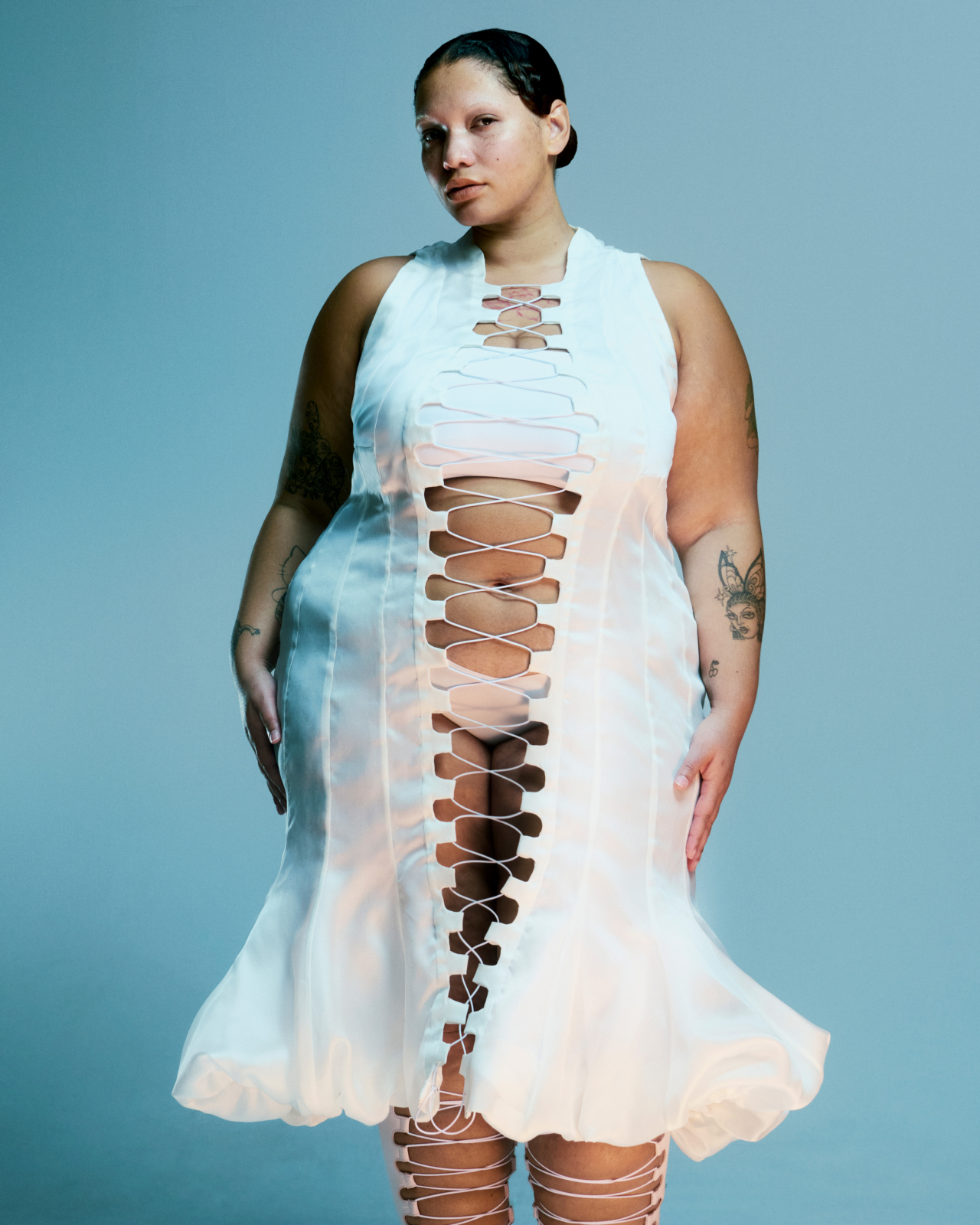 A model wears a white dress.