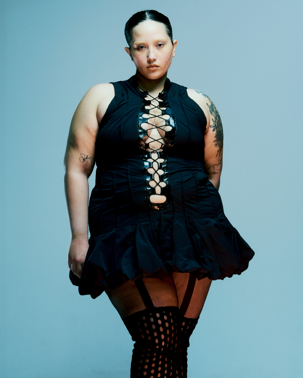 A model wears a black dress.