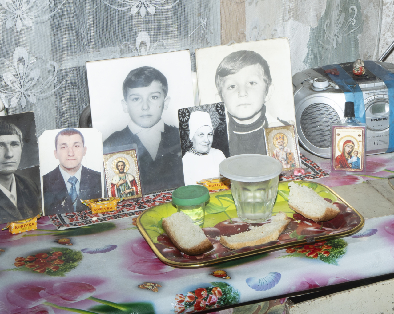 An altar with food and portraits of people.
