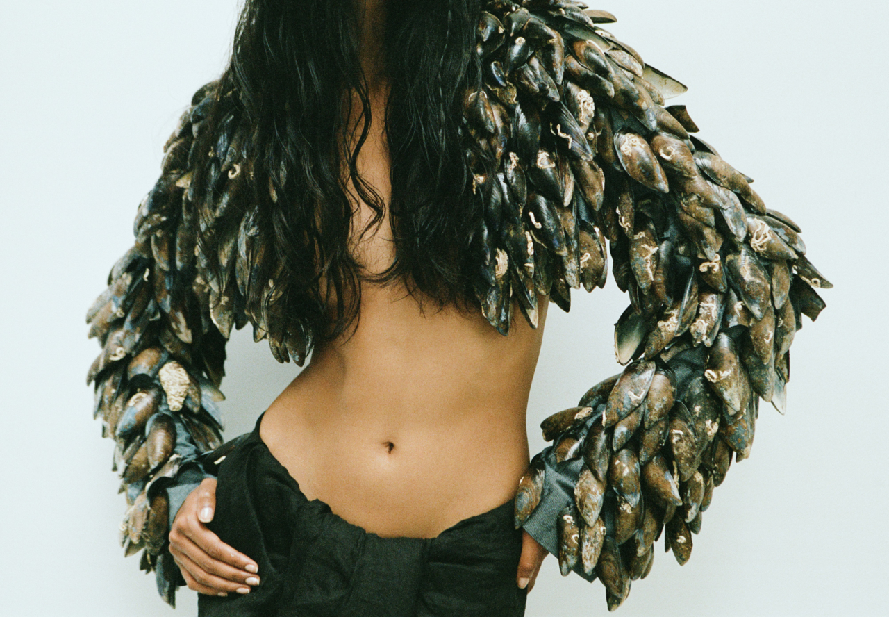 Padani wears George Trochopoulos jacket made from mussels and cotton, custom-made cotton skirt