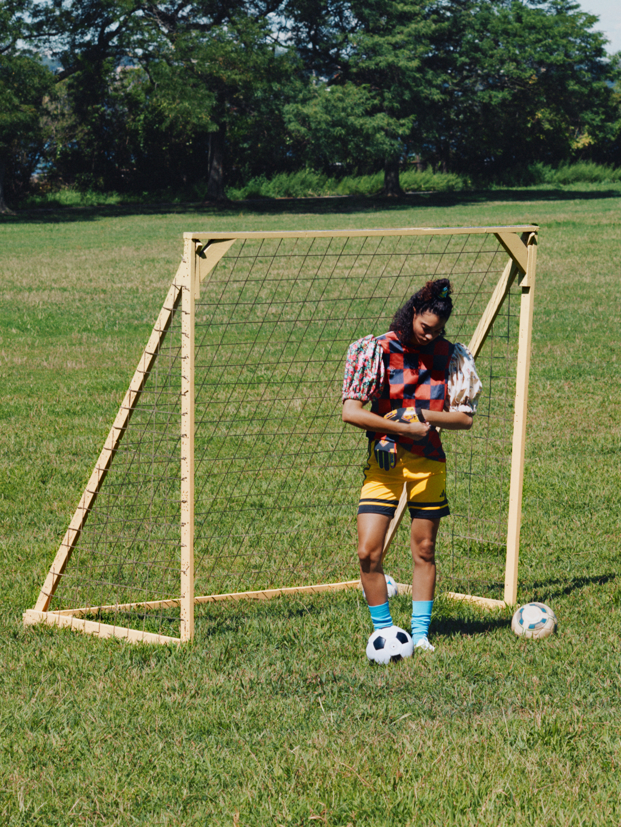 Aliza wears Taylor Dorry custom soccer jersey, Adidas shorts, vintage Reusch gloves, Nike soccer socks, Sokito boots