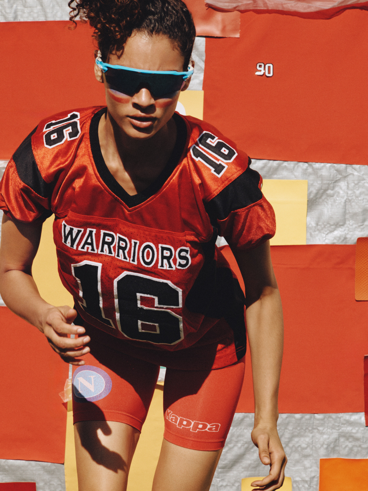 Aliza wears vintage football jersey, Kappa shorts, Oakley sunglasses
