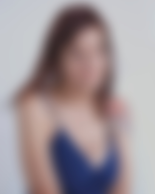 A mother wearing a blue top looks into the distance.