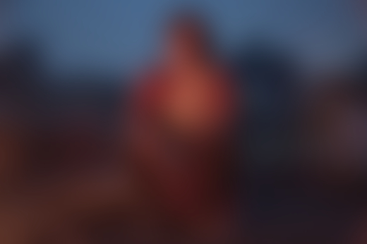 Beauty Devi (34) sits in her village in the evening after burning coal. Many abandoned mines with leftover coal were left unsealed and unsafe.