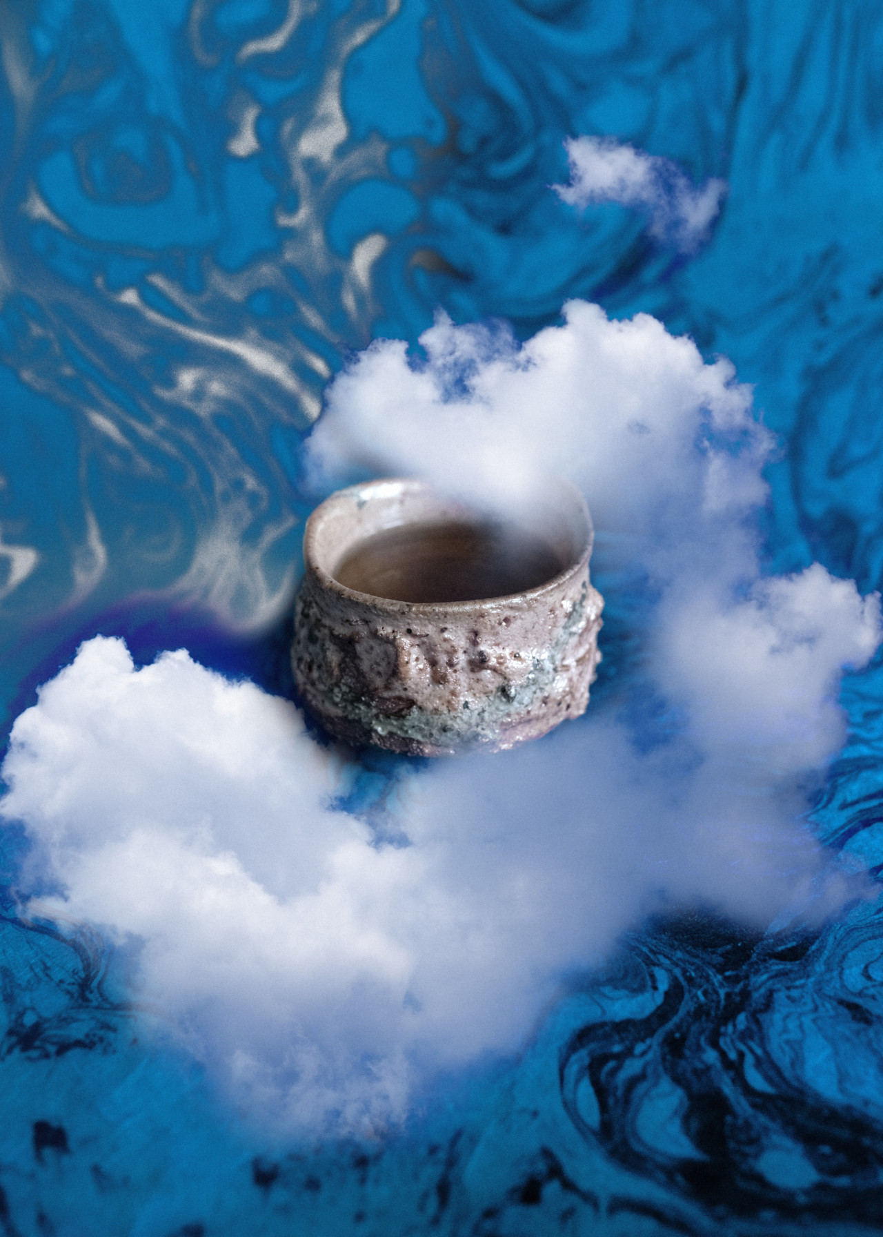 Smoke surrounds a ceramic bowl.