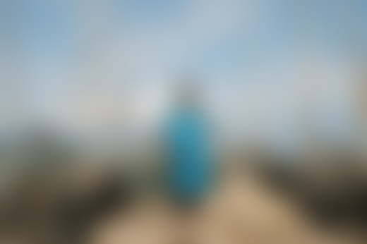 A fisherwoman stands on the shore in Mannar.