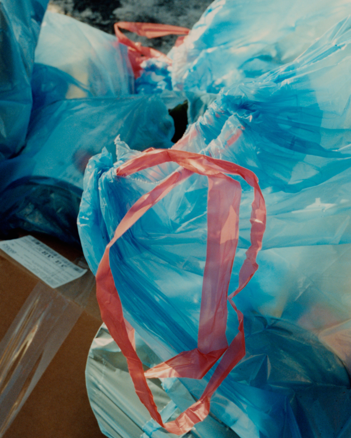 A blue plastic bag filled with trash.