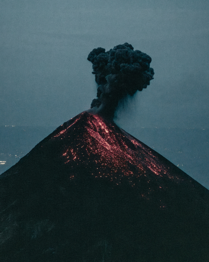 Dark smoke floats from a volcano after an eruption.