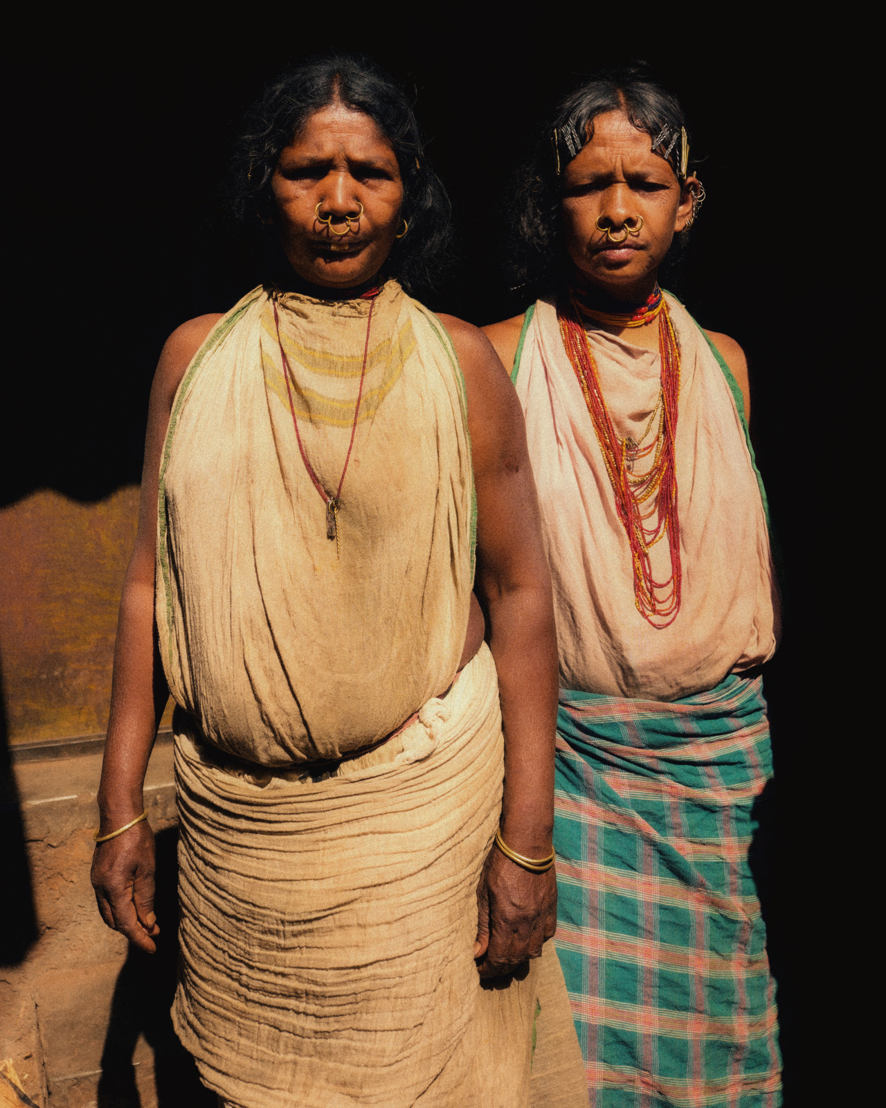 Two women from Odisha, India stand side by side.