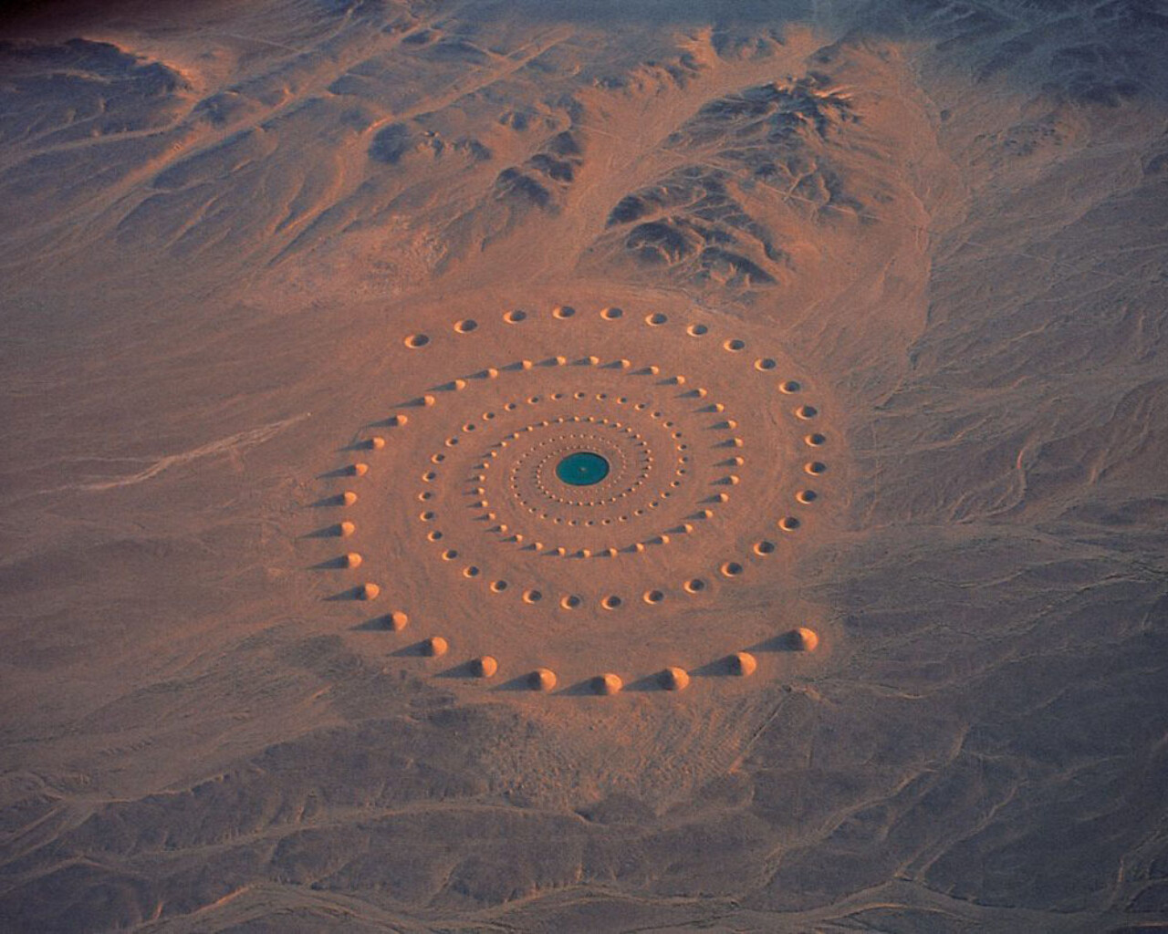 A spiral pattern in the desert sand.