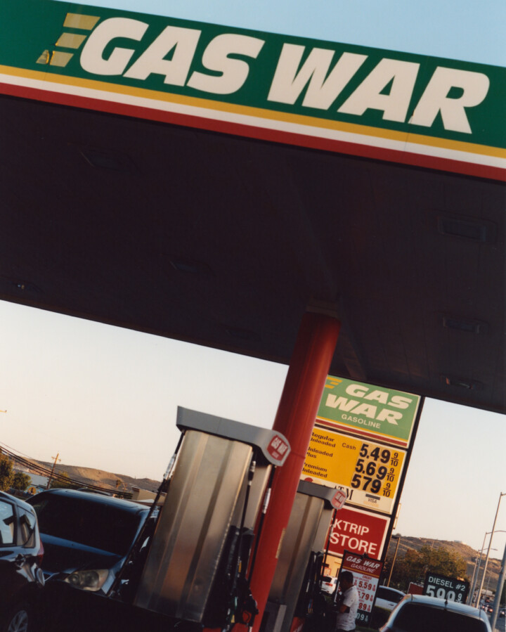 Off-center photograph of a gas station with GAS WAR written where company name would be.