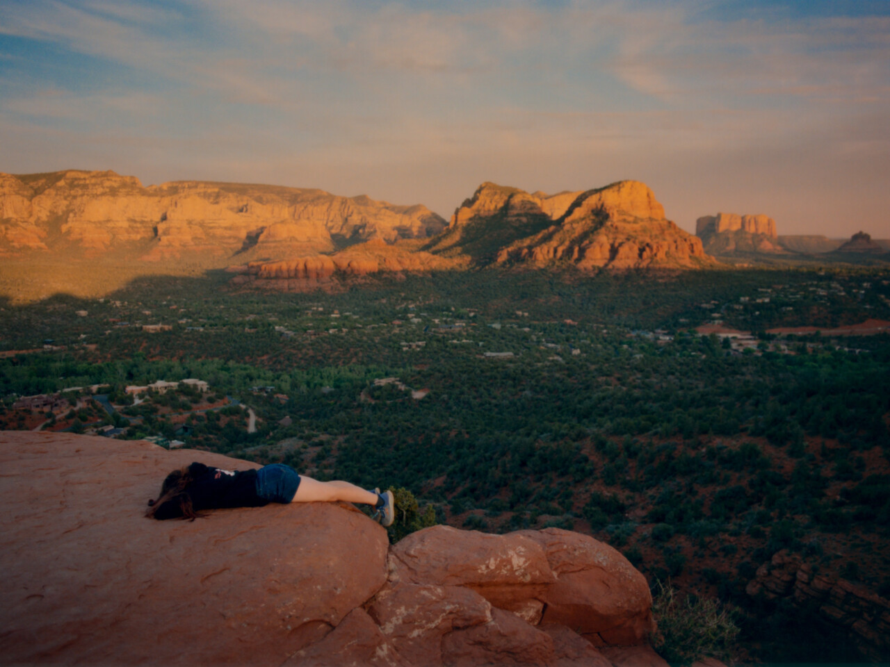 A woman lays down face first to absorb the uniquely powerful vibrational frequencies from the red rocks in what Sedona locals call a 